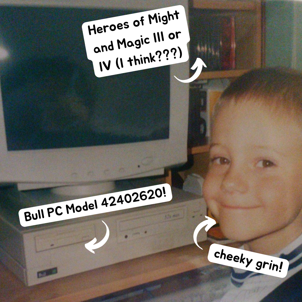 A picture of Luke as a young child in the 2000s sat at a computer desk smiling. Text popouts on the image point to different picture features. #1 points to a Disk rack and reads 'Heroes of Might and Magic III or IV (I think???). #2 points to the computer on the desk and reads 'Bull PC Model 42402620!'. #3 points to Luke and says 'Cheeky Grin!'